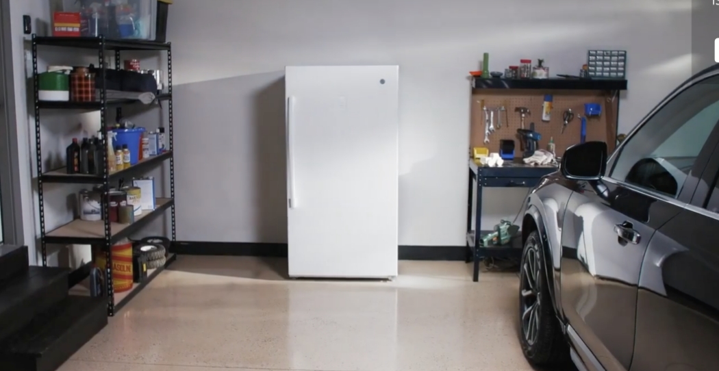 white freezer next to car in garage